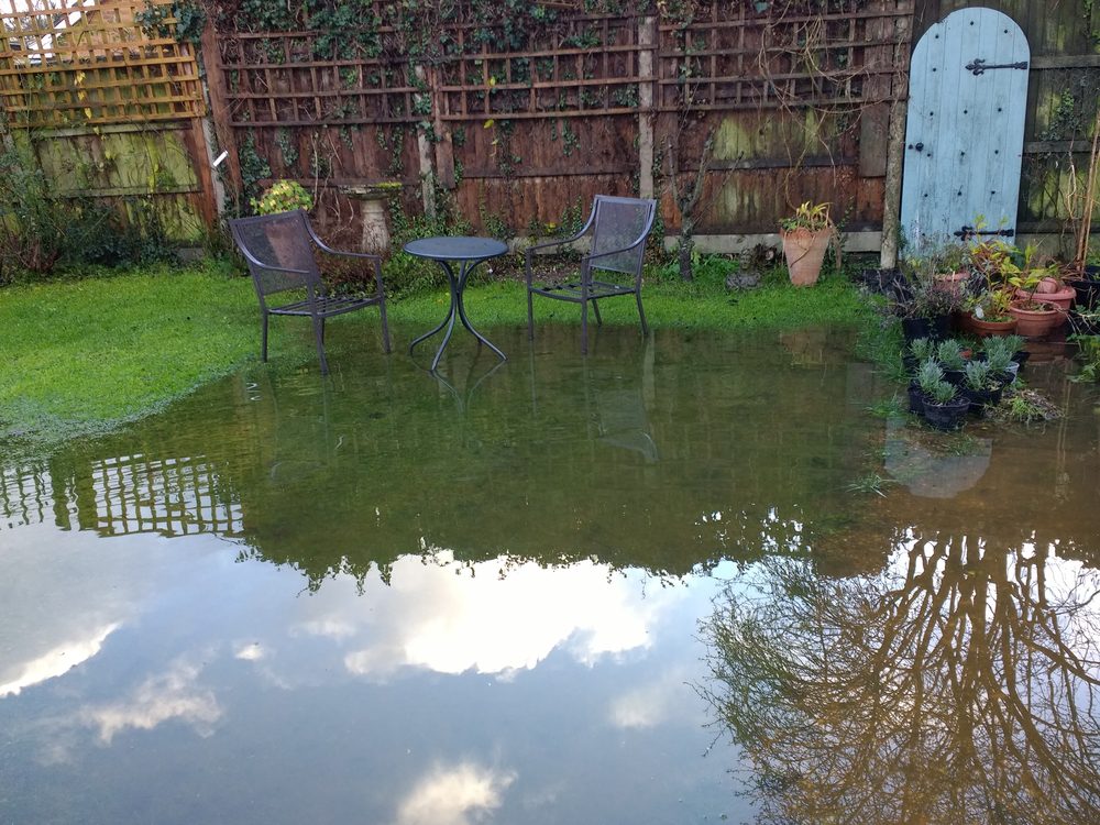 flooded yard with chairs and a table