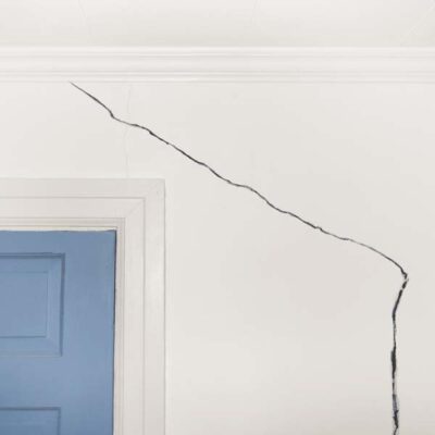 Several factors contribute to the formation of a crack in a foundation wall including differential settlement, hydrostatic pressure, and shrinkage.